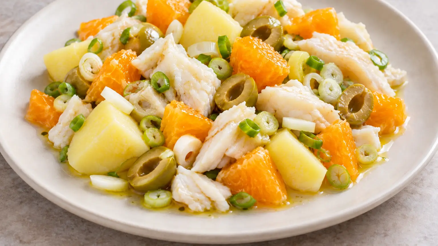 Málaga salad with cod, orange, potatoes, green olives and thinly sliced scallions