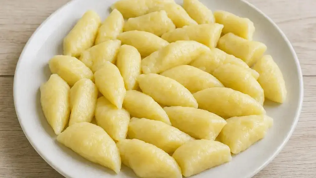 Soft classic kopytka potato dumplings served on a plate
